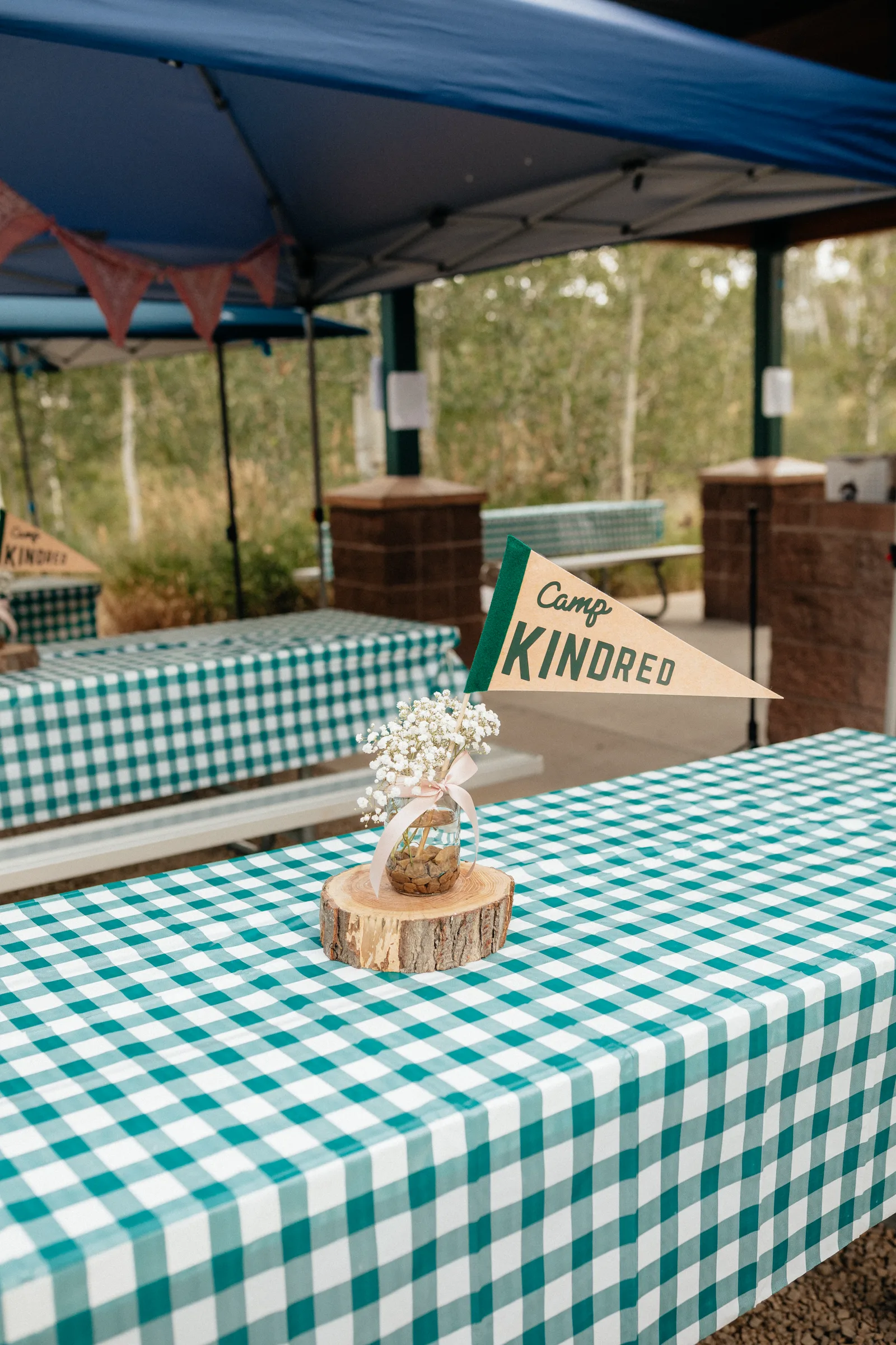 A Camp Kindred gathering space with decorated tables and a camp banner