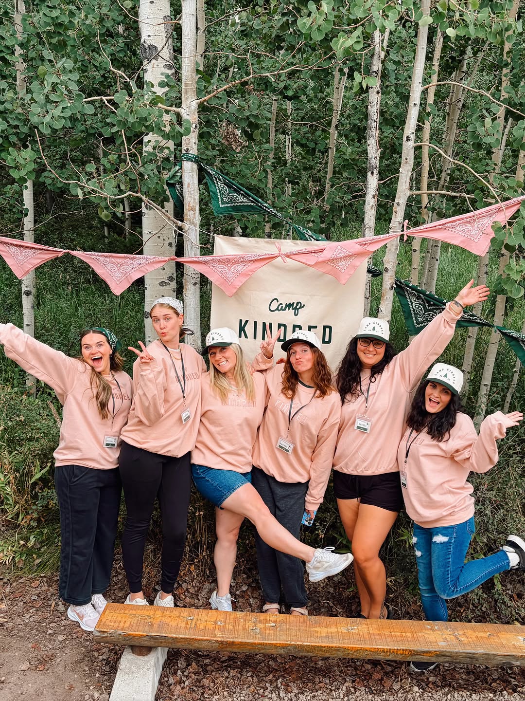 Six Camp Kindred women in matching pink sweatshirts and hats